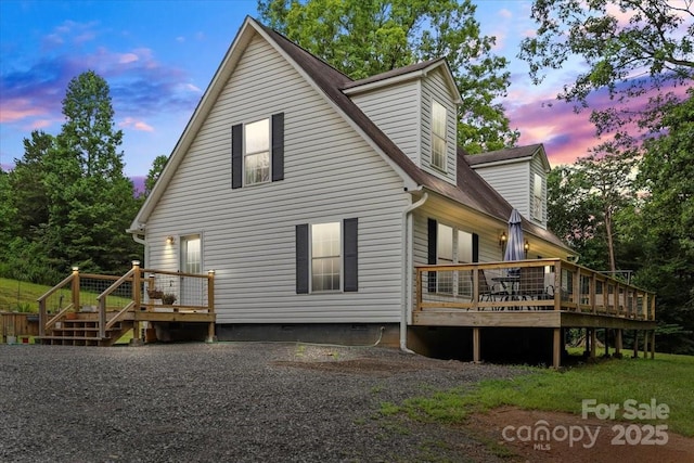 1764 Tomlinson Loop, Connelly Springs, NC 28612 - back of property at dusk featuring a deck and crawl space