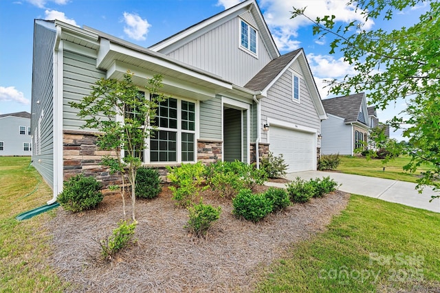 5846 Oak Branch Cir, Maiden, NC 28650 - view of front of property featuring board and batten siding, a front lawn, a garage, concrete driveway, and stone siding