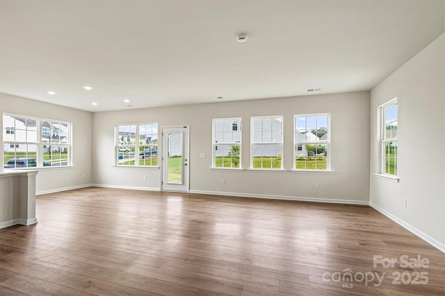 5846 Oak Branch Cir, Maiden, NC 28650 - empty room featuring plenty of natural light, a smoke detector, wood finished floors, and recessed lighting