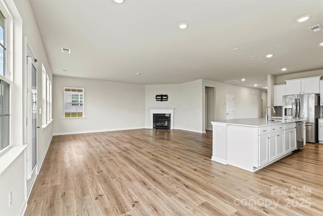5846 Oak Branch Cir, Maiden, NC 28650 - kitchen with appliances with stainless steel finishes, white cabinetry, open floor plan, light wood-type flooring, and recessed lighting