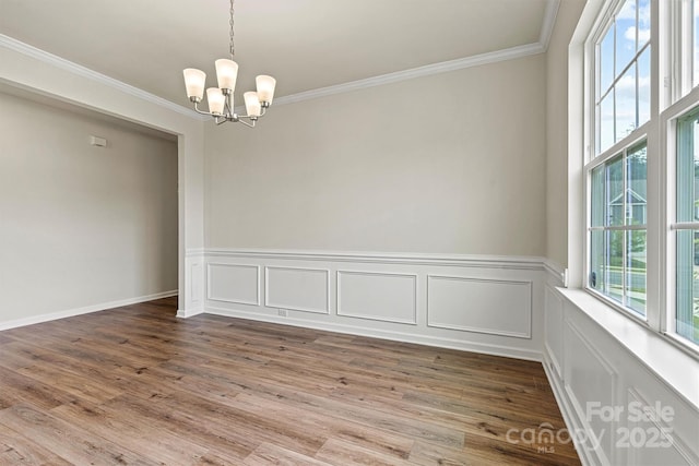 5846 Oak Branch Cir, Maiden, NC 28650 - spare room featuring a chandelier, crown molding, wood finished floors, and wainscoting