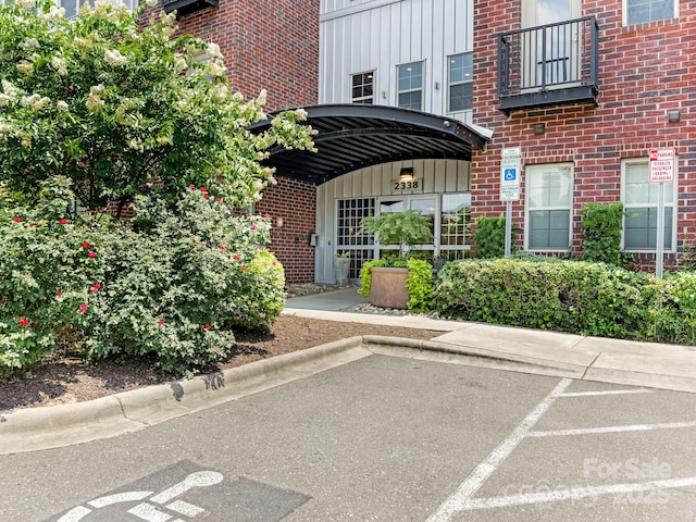 2338 Yadkin Ave Unit 505, Charlotte, NC 28205 - property entrance featuring board and batten siding, uncovered parking, and brick siding