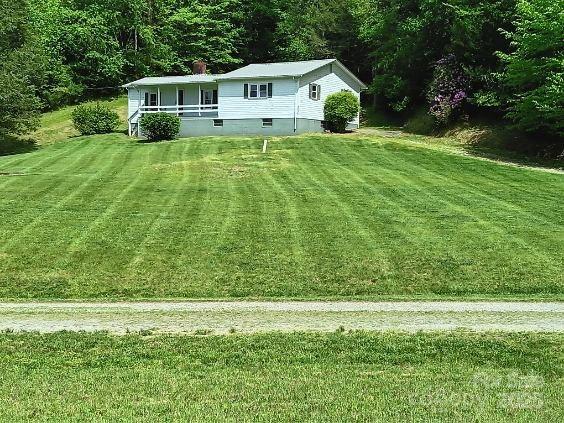 2255 NC Highway 268 W, Wilkesboro, NC 28697 - view of green lawn featuring covered porch and a forest view