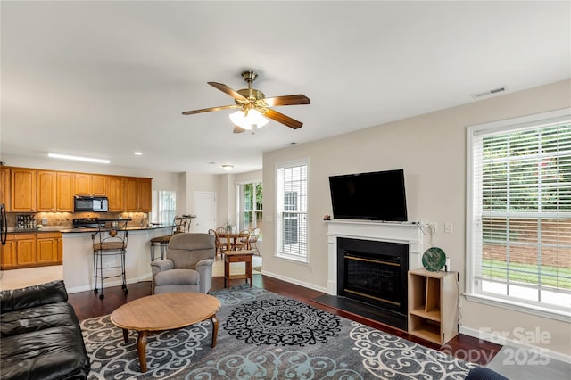 1993 W Foxwood Ct, Indian Land, SC 29707 - living area featuring ceiling fan, dark wood-type flooring, a fireplace with flush hearth, and recessed lighting