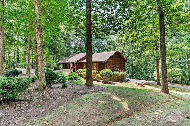 1408 Kensington Cir, Newton, NC 28658 - view of front of home with a chimney, covered porch, and a view of trees