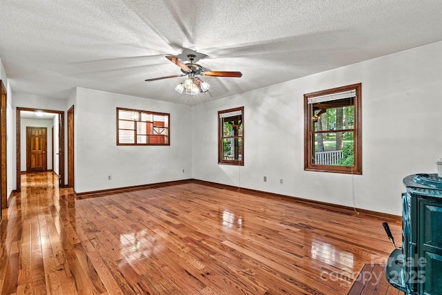 1408 Kensington Cir, Newton, NC 28658 - unfurnished living room with hardwood / wood-style flooring, plenty of natural light, ceiling fan, and a textured ceiling