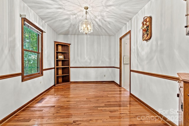 1408 Kensington Cir, Newton, NC 28658 - spare room featuring light wood-style flooring and a chandelier
