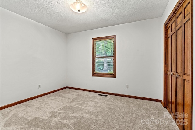 1408 Kensington Cir, Newton, NC 28658 - unfurnished bedroom with carpet floors, a textured ceiling, and a closet