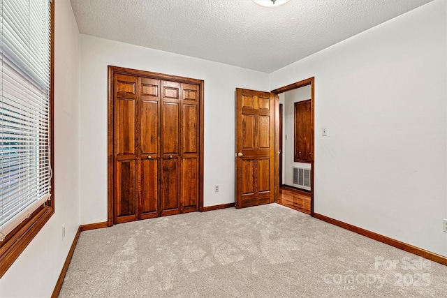 1408 Kensington Cir, Newton, NC 28658 - unfurnished bedroom featuring carpet flooring, a closet, and a textured ceiling