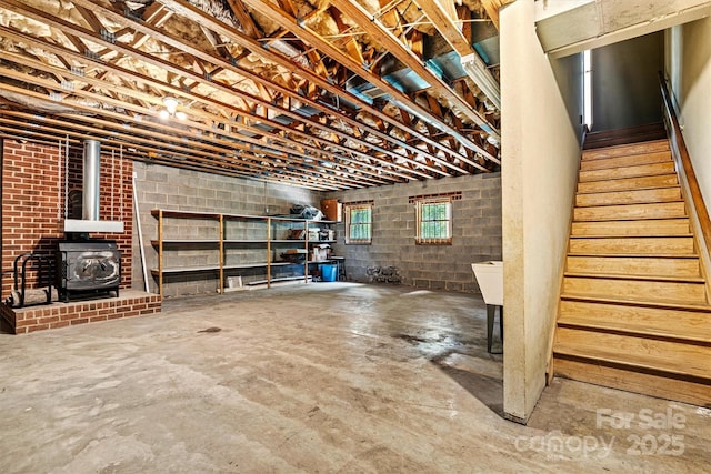 1408 Kensington Cir, Newton, NC 28658 - below grade area featuring a wood stove and stairway