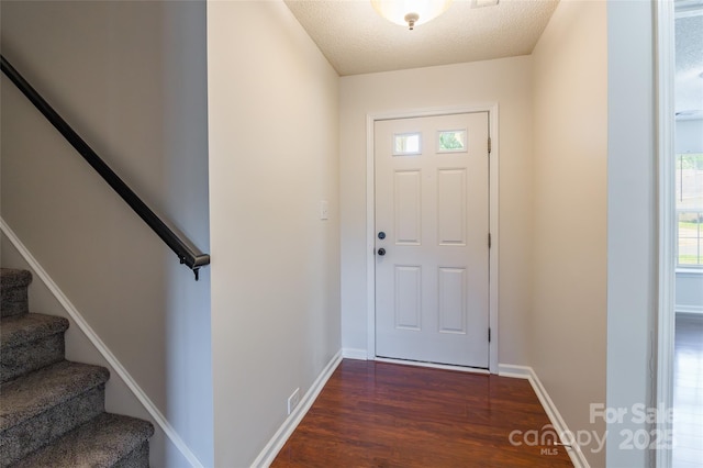 14924 Jerpoint Abby Dr, Charlotte, NC 28273 - entryway featuring dark wood-style floors, stairs, and a textured ceiling