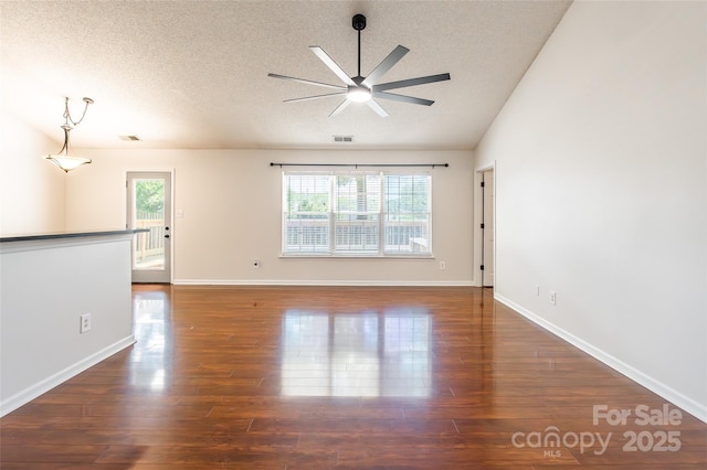 14924 Jerpoint Abby Dr, Charlotte, NC 28273 - empty room with ceiling fan, healthy amount of natural light, wood finished floors, a textured ceiling, and vaulted ceiling