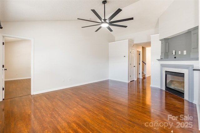 14924 Jerpoint Abby Dr, Charlotte, NC 28273 - unfurnished living room with ceiling fan, high vaulted ceiling, wood finished floors, a tile fireplace, and stairs