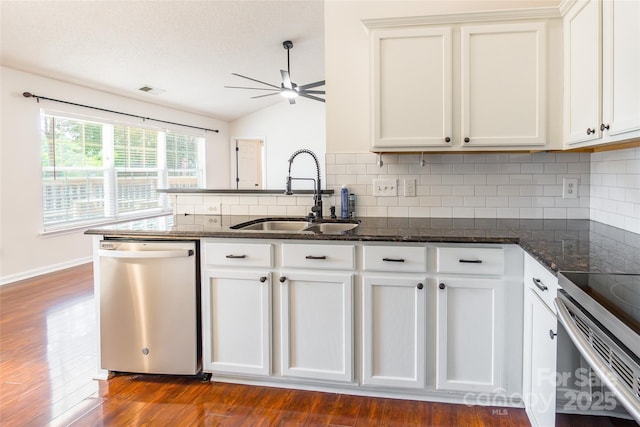 14924 Jerpoint Abby Dr, Charlotte, NC 28273 - kitchen with appliances with stainless steel finishes, ceiling fan, dark wood-style flooring, backsplash, and a peninsula