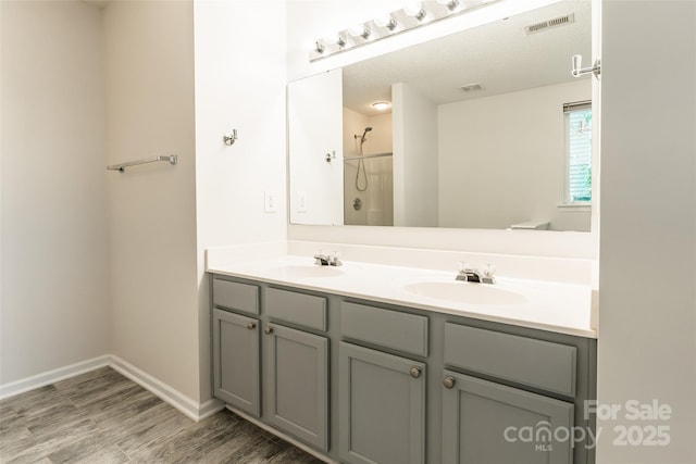 14924 Jerpoint Abby Dr, Charlotte, NC 28273 - full bathroom featuring double vanity, wood finished floors, and a shower