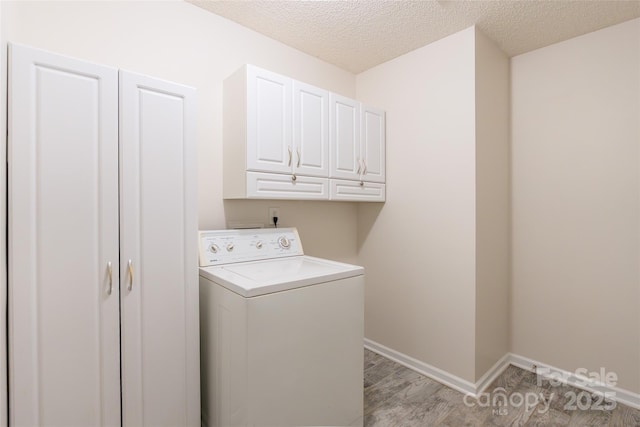 14924 Jerpoint Abby Dr, Charlotte, NC 28273 - washroom with washer / dryer, cabinet space, a textured ceiling, and light wood-style flooring