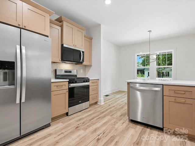 4113 Rutgers Ave, Charlotte, NC 28206 - kitchen with stainless steel appliances, light countertops, light wood-style floors, backsplash, and recessed lighting