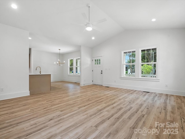 4113 Rutgers Ave, Charlotte, NC 28206 - unfurnished living room with a ceiling fan, a chandelier, light wood-style floors, vaulted ceiling, and recessed lighting