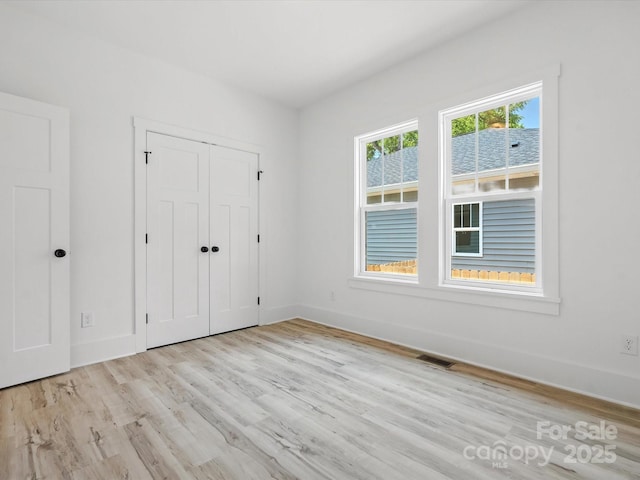 4113 Rutgers Ave, Charlotte, NC 28206 - unfurnished bedroom featuring light wood-style flooring and a closet