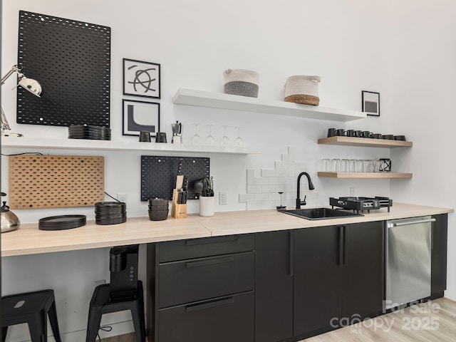 1759 Williamson Creek Rd, Pisgah Forest, NC 28768 - indoor wet bar with tasteful backsplash, dishwasher, and light wood-style floors