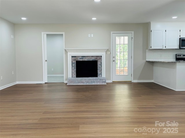 2443 1st Street Pl NW, Hickory, NC 28601 - unfurnished living room with recessed lighting, wood finished floors, and a brick fireplace