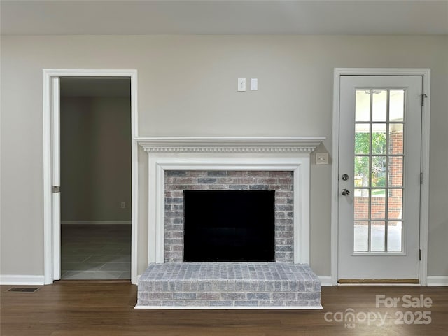 2443 1st Street Pl NW, Hickory, NC 28601 - detailed view of wood finished floors and a brick fireplace
