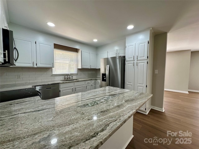 2443 1st Street Pl NW, Hickory, NC 28601 - kitchen featuring stainless steel appliances, light stone countertops, tasteful backsplash, white cabinetry, and recessed lighting