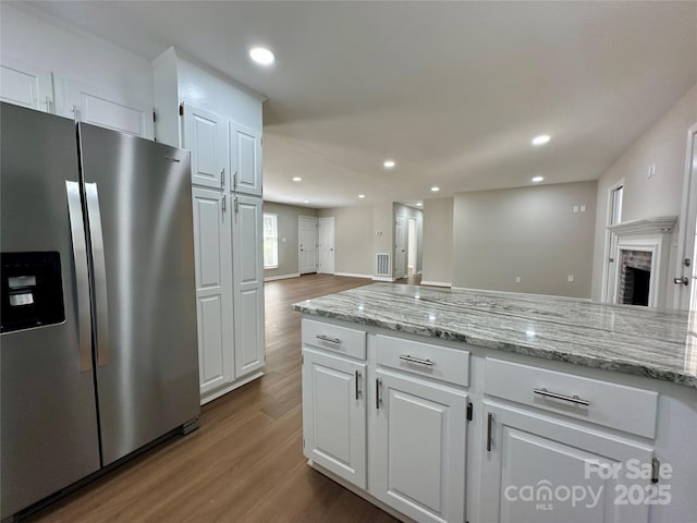 2443 1st Street Pl NW, Hickory, NC 28601 - kitchen featuring stainless steel refrigerator with ice dispenser, wood finished floors, recessed lighting, white cabinetry, and open floor plan