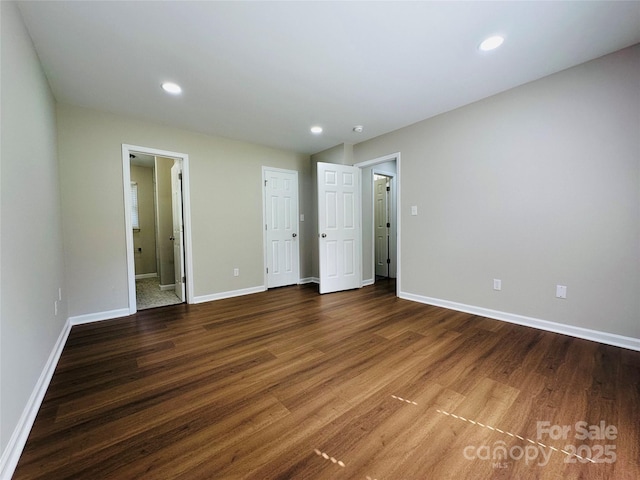 2443 1st Street Pl NW, Hickory, NC 28601 - unfurnished bedroom featuring wood finished floors, recessed lighting, and connected bathroom