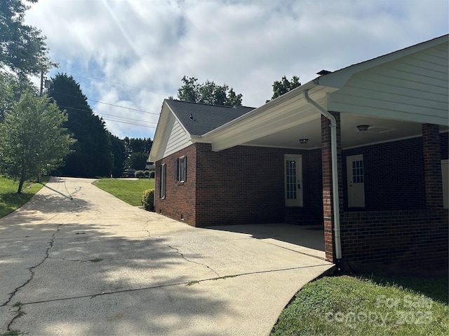 2443 1st Street Pl NW, Hickory, NC 28601 - view of home's exterior with brick siding, a carport, and driveway