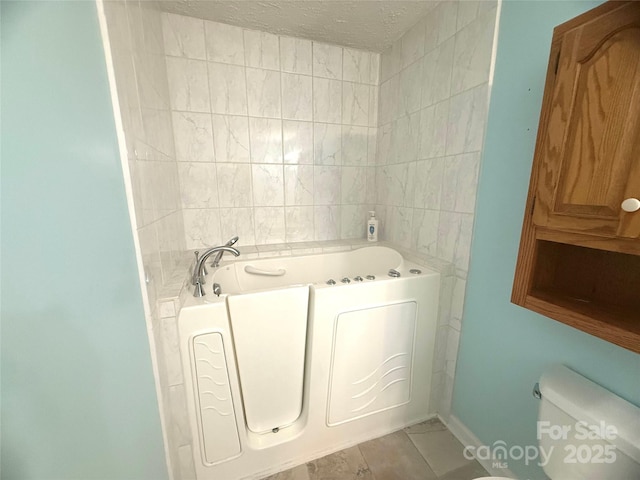 2832 Laurel Ln, Lenoir, NC 28645 - bathroom featuring a bath, tile patterned flooring, and a textured ceiling