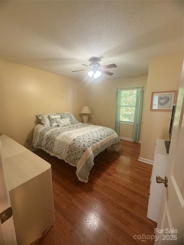 2832 Laurel Ln, Lenoir, NC 28645 - bedroom featuring wood finished floors, a textured ceiling, and ceiling fan