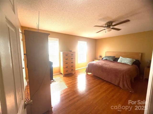 2832 Laurel Ln, Lenoir, NC 28645 - bedroom featuring wood finished floors, a textured ceiling, and a ceiling fan