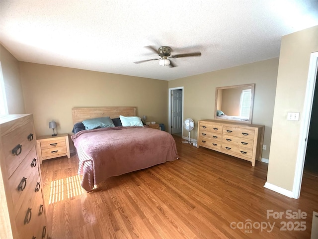 2832 Laurel Ln, Lenoir, NC 28645 - bedroom with wood finished floors, a textured ceiling, a closet, and a ceiling fan