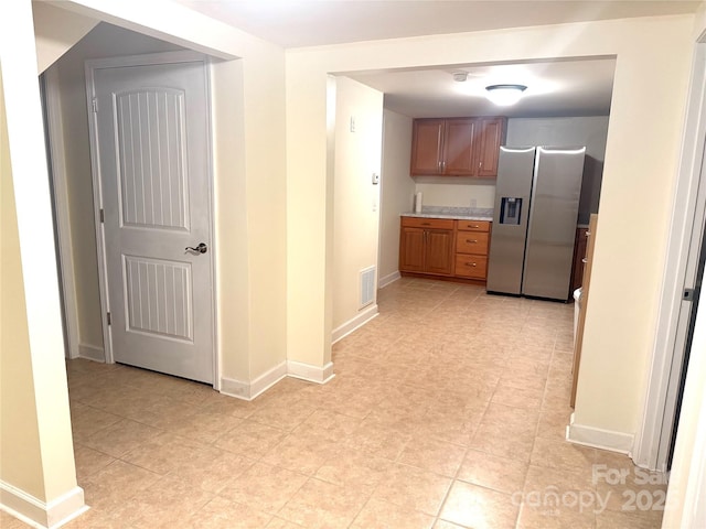 2832 Laurel Ln, Lenoir, NC 28645 - kitchen with stainless steel fridge, light countertops, and brown cabinetry
