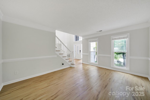 10807 Summitt Tree Ct, Charlotte, NC 28277 - unfurnished living room featuring wood finished floors, stairway, and crown molding