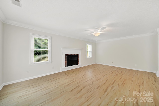 10807 Summitt Tree Ct, Charlotte, NC 28277 - unfurnished living room with a ceiling fan, light wood-style floors, crown molding, and a brick fireplace
