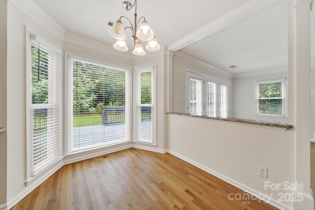10807 Summitt Tree Ct, Charlotte, NC 28277 - unfurnished dining area with a textured ceiling, a chandelier, wood finished floors, and crown molding