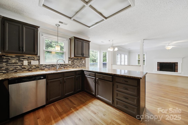 10807 Summitt Tree Ct, Charlotte, NC 28277 - kitchen with stainless steel dishwasher, a peninsula, light wood-type flooring, backsplash, and light stone countertops