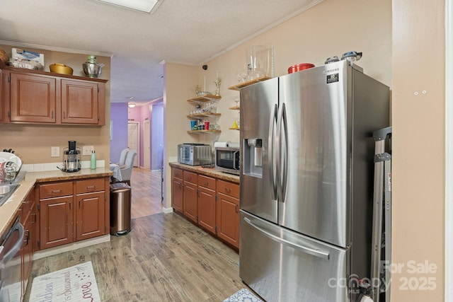115 Red Fox Ct, Mount Holly, NC 28120 - kitchen with appliances with stainless steel finishes, light wood finished floors, crown molding, brown cabinets, and open shelves