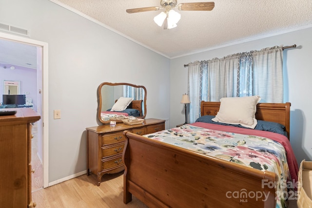 115 Red Fox Ct, Mount Holly, NC 28120 - bedroom featuring light wood finished floors, ornamental molding, a textured ceiling, vaulted ceiling, and ceiling fan