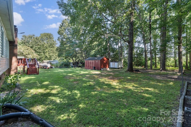 115 Red Fox Ct, Mount Holly, NC 28120 - view of green lawn featuring a shed, stairway, and a wooden deck