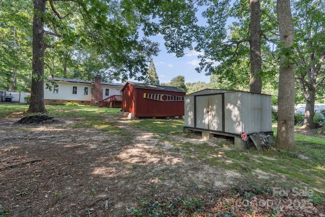 115 Red Fox Ct, Mount Holly, NC 28120 - view of yard featuring a storage unit and a deck
