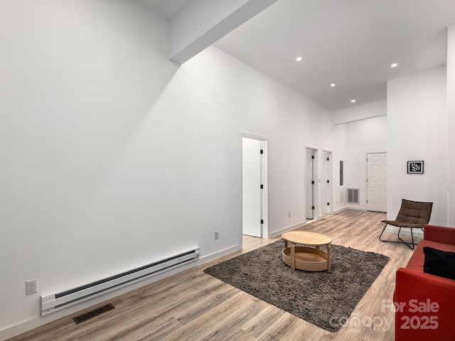 1761 Williamson Creek Rd, Pisgah Forest, NC 28768 - living room featuring a baseboard heating unit, a high ceiling, light wood-style floors, and recessed lighting