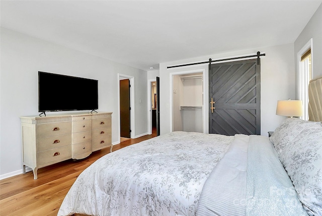 4906 Crooked Oak Ln, Charlotte, NC 28226 - bedroom featuring light wood finished floors and a barn door