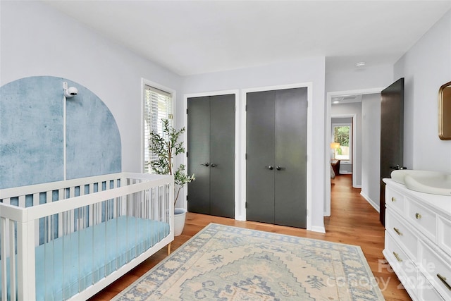 4906 Crooked Oak Ln, Charlotte, NC 28226 - bedroom featuring multiple closets and light wood-style floors