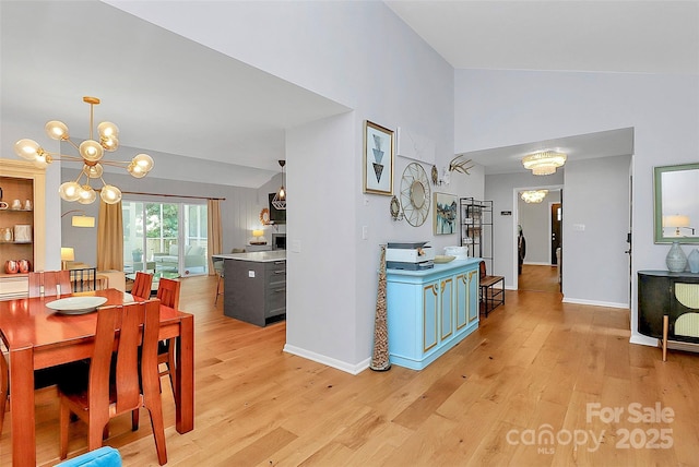 4906 Crooked Oak Ln, Charlotte, NC 28226 - dining space featuring a chandelier, light wood-style floors, and high vaulted ceiling