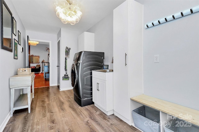 4906 Crooked Oak Ln, Charlotte, NC 28226 - laundry area featuring washer / clothes dryer, light wood finished floors, a chandelier, and cabinet space