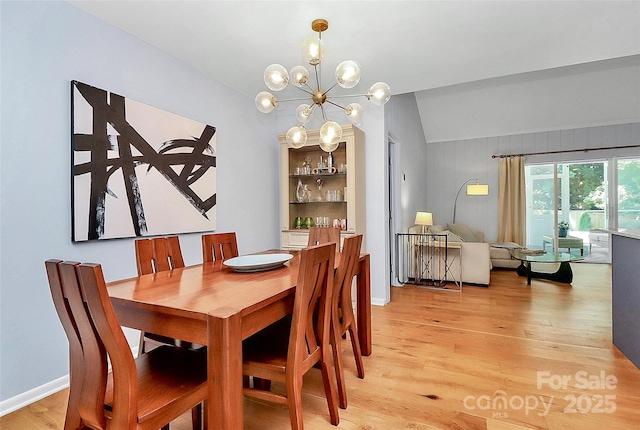 4906 Crooked Oak Ln, Charlotte, NC 28226 - dining room featuring light wood finished floors, a chandelier, and lofted ceiling