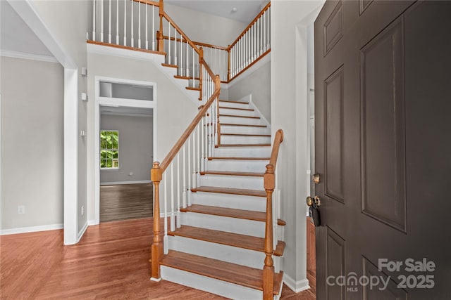 145 Summerbrook Ln, Mooresville, NC 28117 - stairway with wood finished floors, crown molding, and a towering ceiling